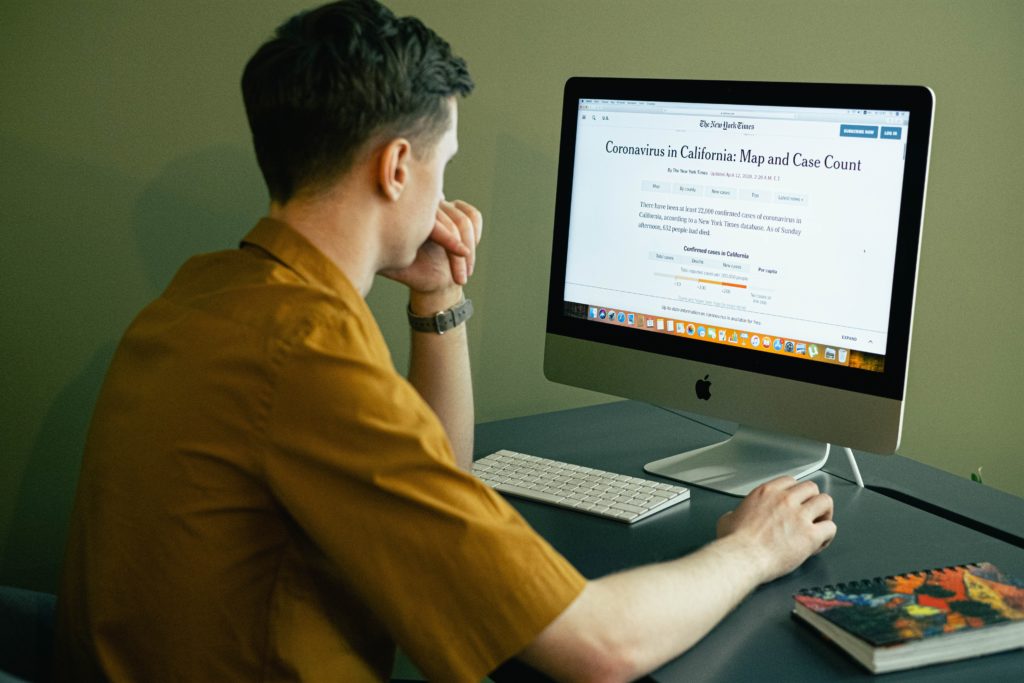 man reading news on internet